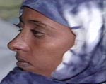 Woman wearing a headscarf inside a boat arrving to the island.